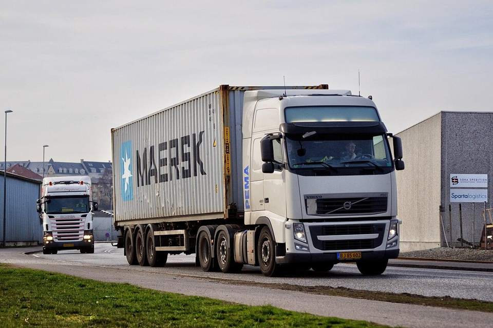 Shipping container loaded on a transport truck