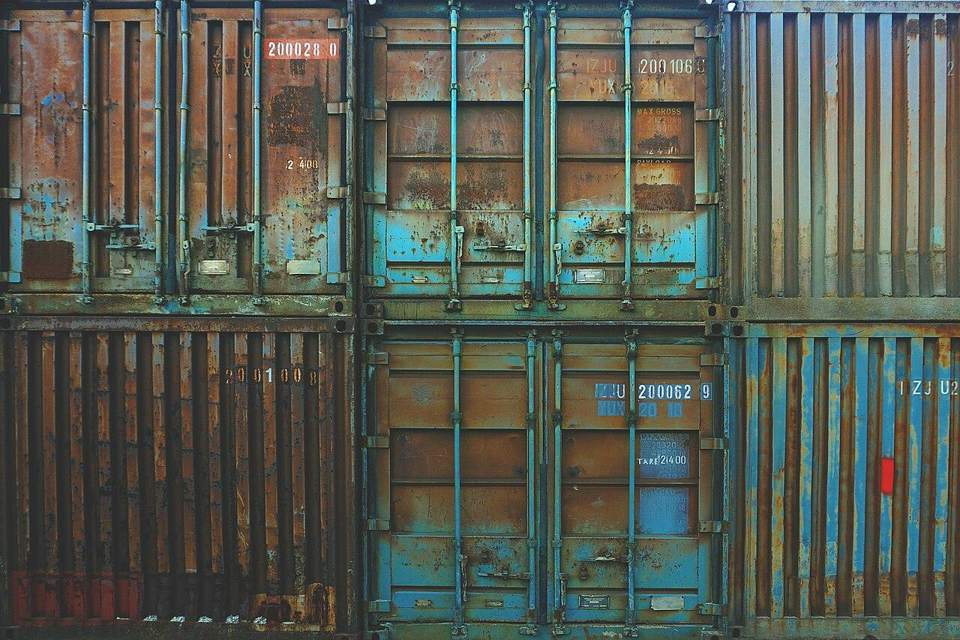 Stacked used shipping containers with weathered doors
